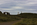 Newborough National Nature Reserve scene from Llanddwyn Island featuring the remains of Llanddwyn Chapel, the cross of St Dwynwen and Twr Mawr Lighthhouse, Isle of Anglesey, North Wales
