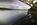 Unique view and partial reflection of the Grade II Listed Britannia Bridge looking northwards along the treacherous waters of the Menai Strait, Gwynedd, North Wales